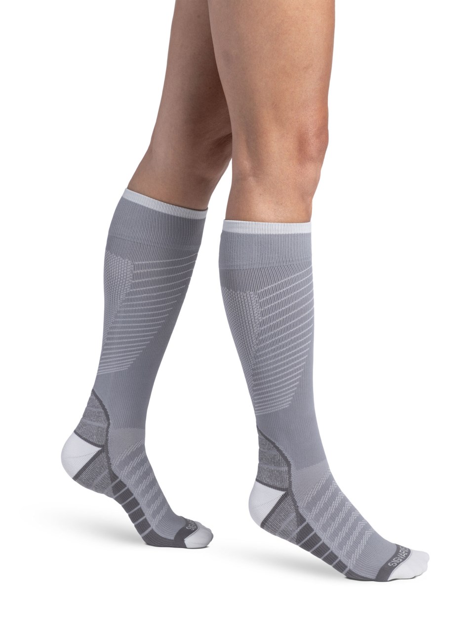 Woman wearing Motion Flow Tech compression socks in the color Cool Grey