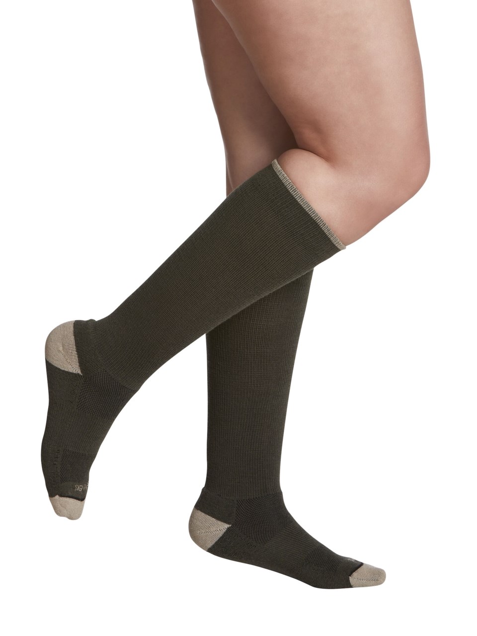 Female wearing MOTION THERMOREGULATING WOOL compression socks in OLIVE